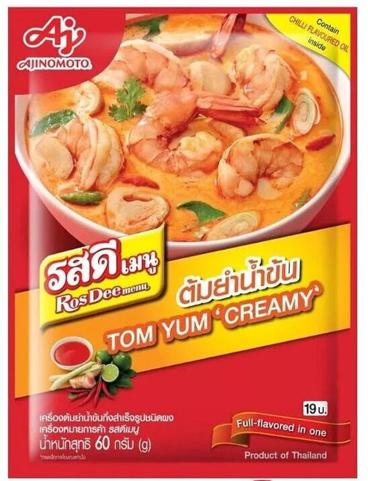 Front of Ajinomoto RosDee Tom Yum Creamy Soup Mix (60g) – A red pack of Thai Tom Yum soup mix with an image of a creamy, spicy, and aromatic Tom Yum soup filled with prawns, mushrooms, and Thai herbs. The label highlights "Full-flavored in one" and mentions chilli flavoured oil inside.